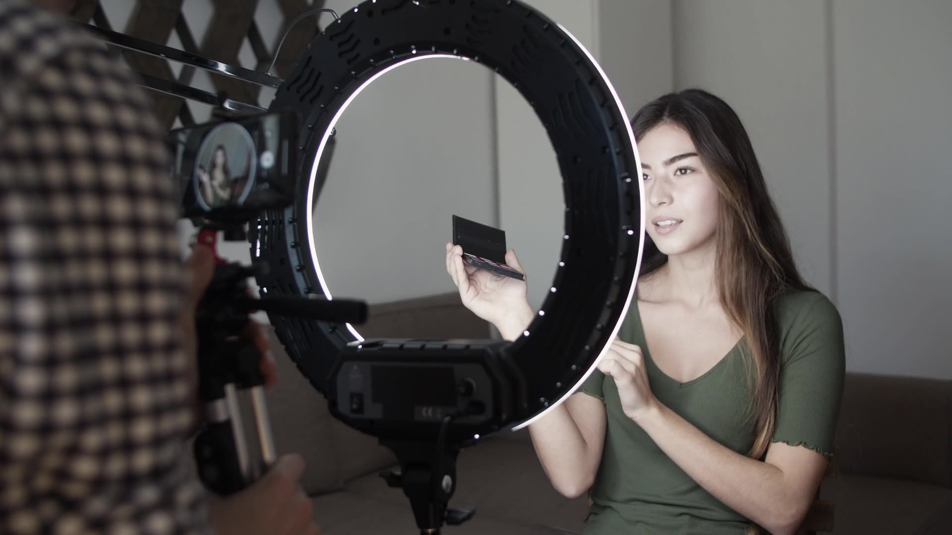 Short-form video strategy: a content creator filming herself with a ring light