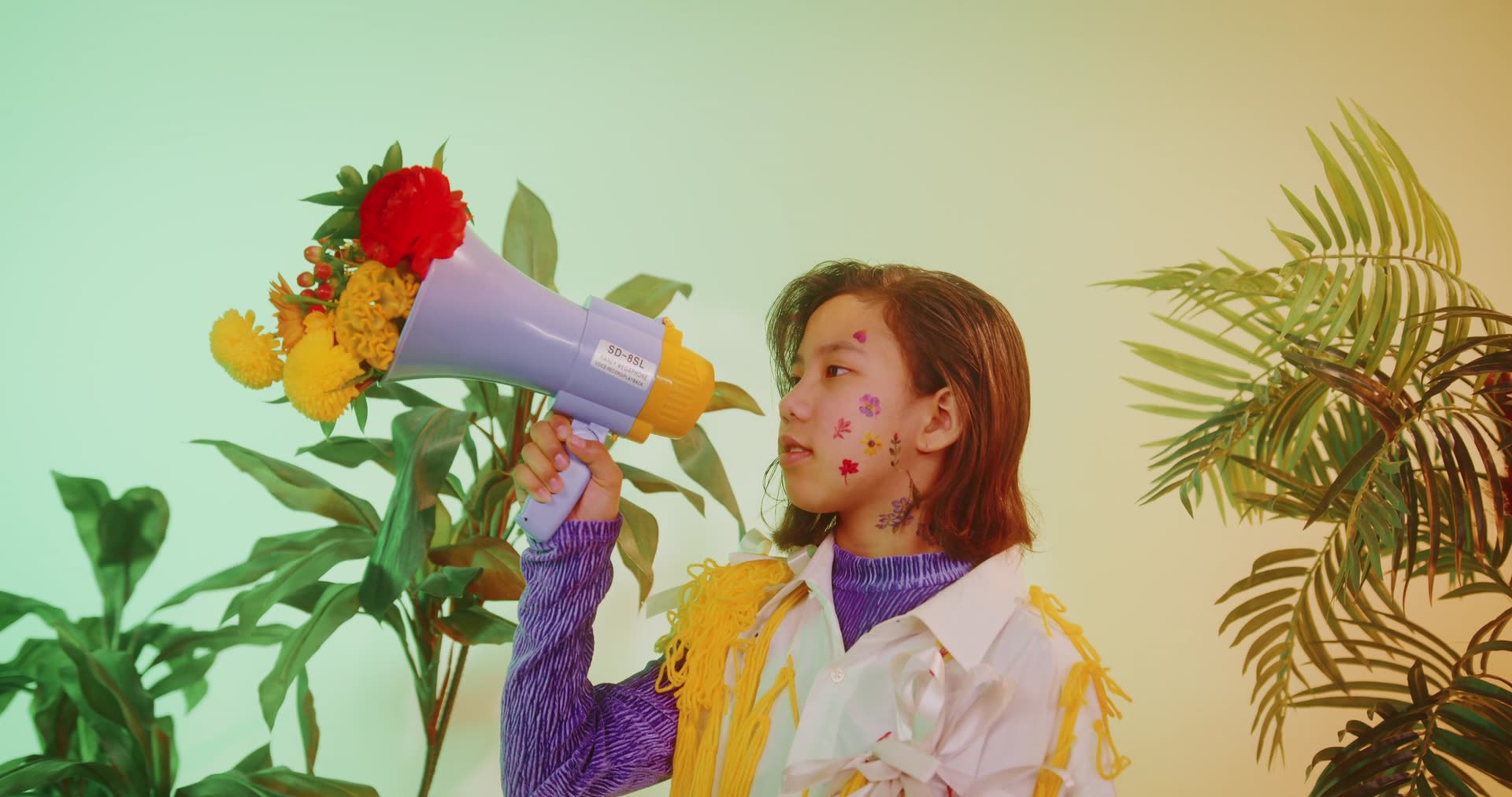 A person holding a megaphone filled with flowers