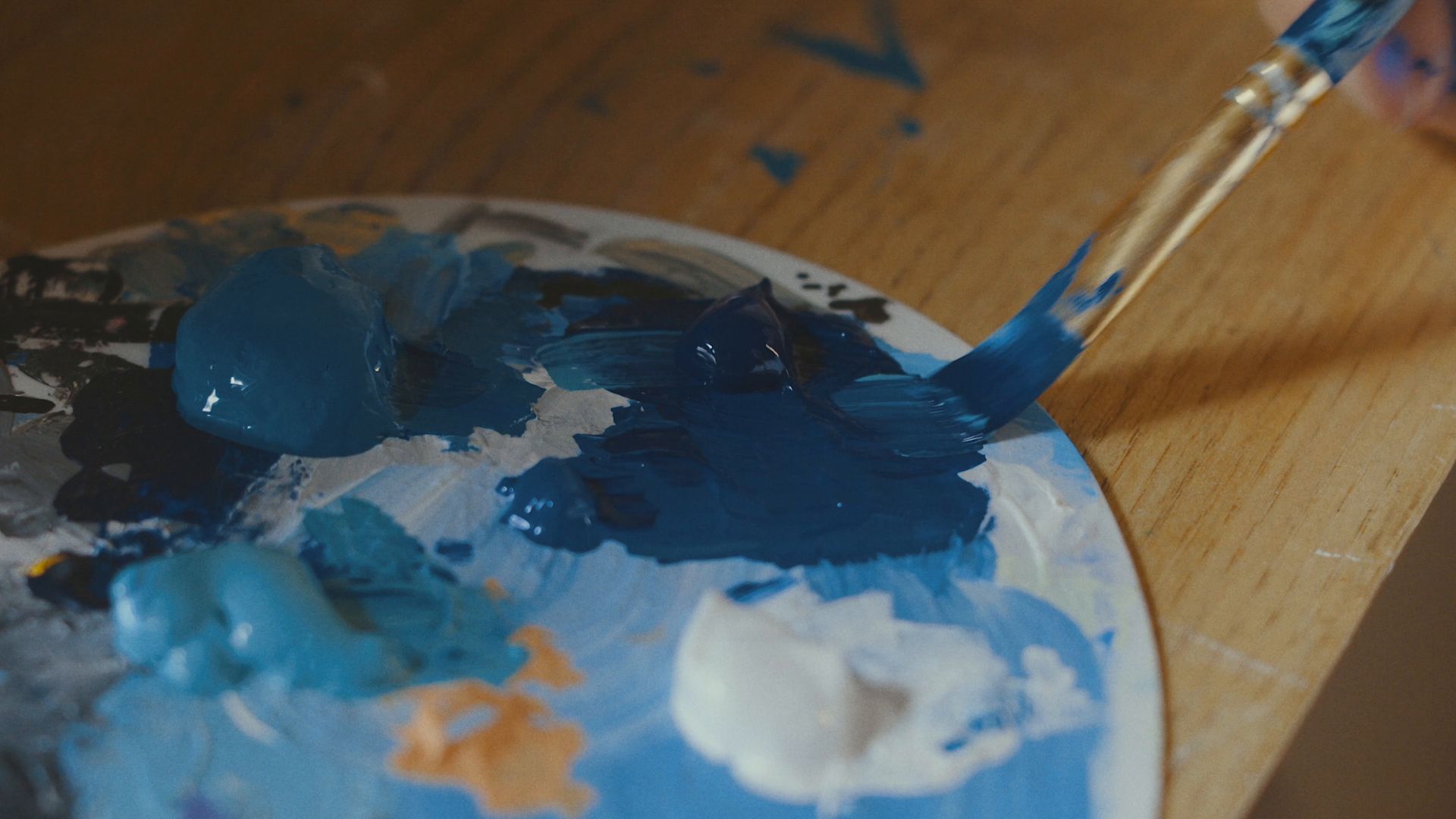 Branding cost in Nigeria: blue paint being mixed on a palette
