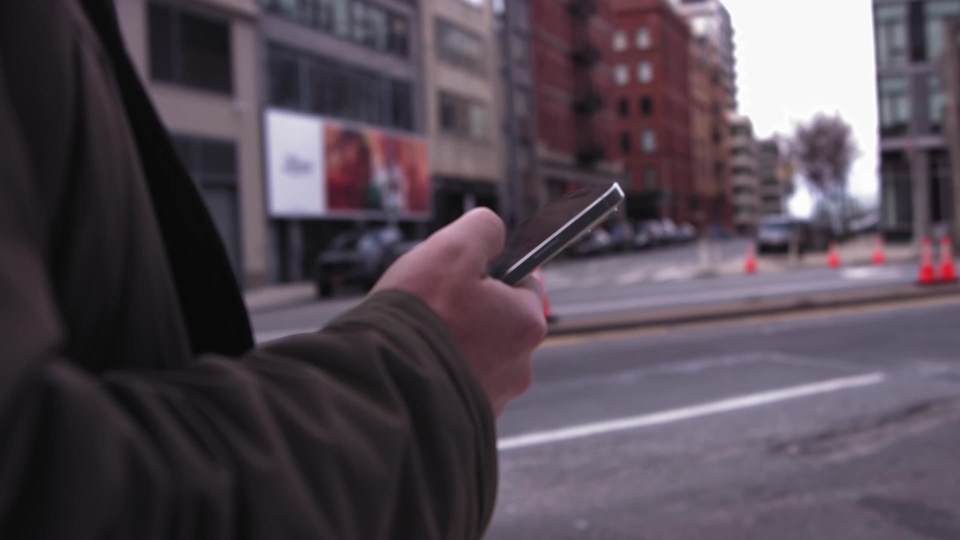 A person using a phone on a city street