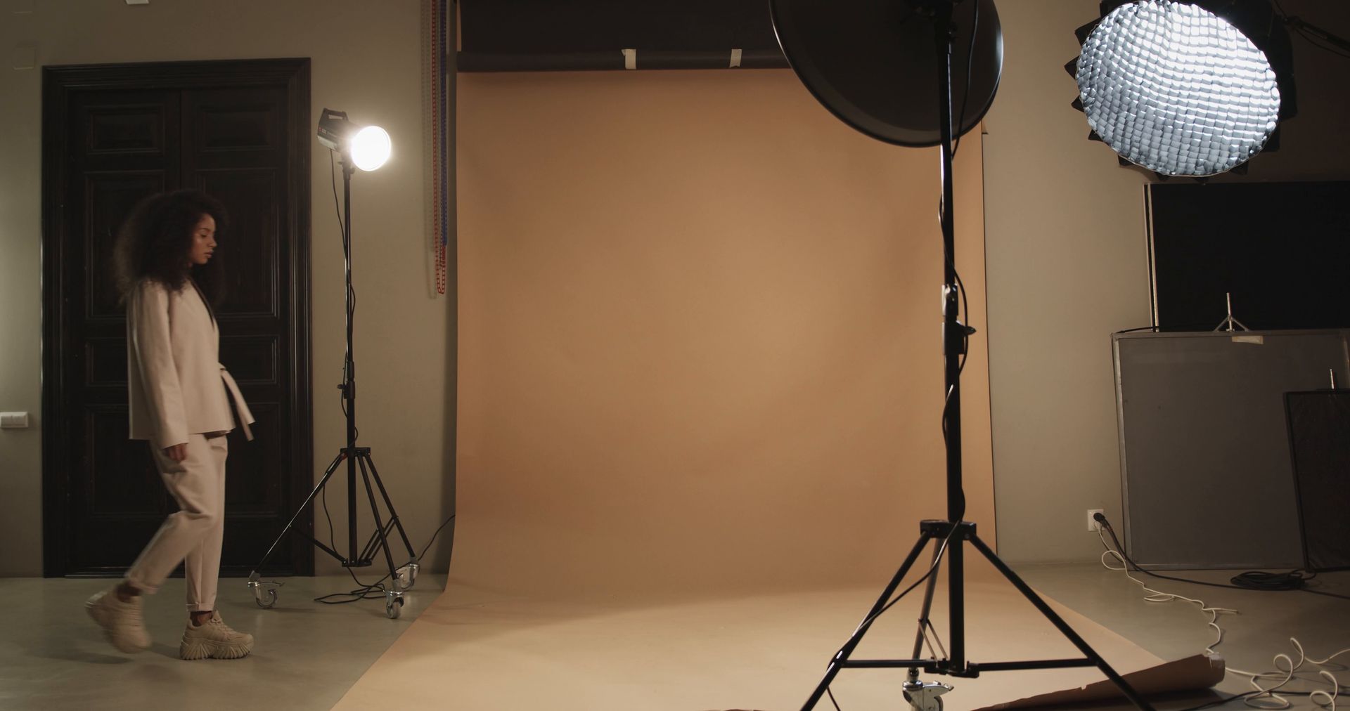 Product photography: a model walking onto a photo set under studio lights